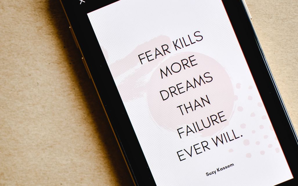 Phone screen saying Fear Kills More Dreams Than Failure Ever Will - Suzy Kassem