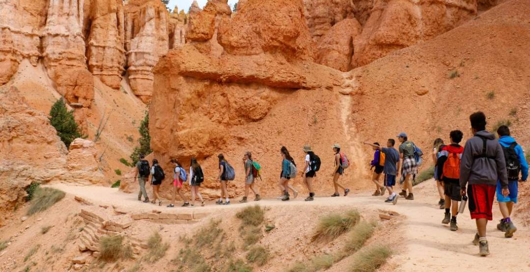 Photo of group of hikers on a mountain path - follow the leader